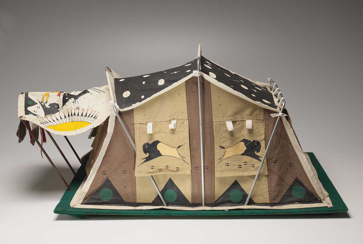 A painted model tent made of cloth and metal