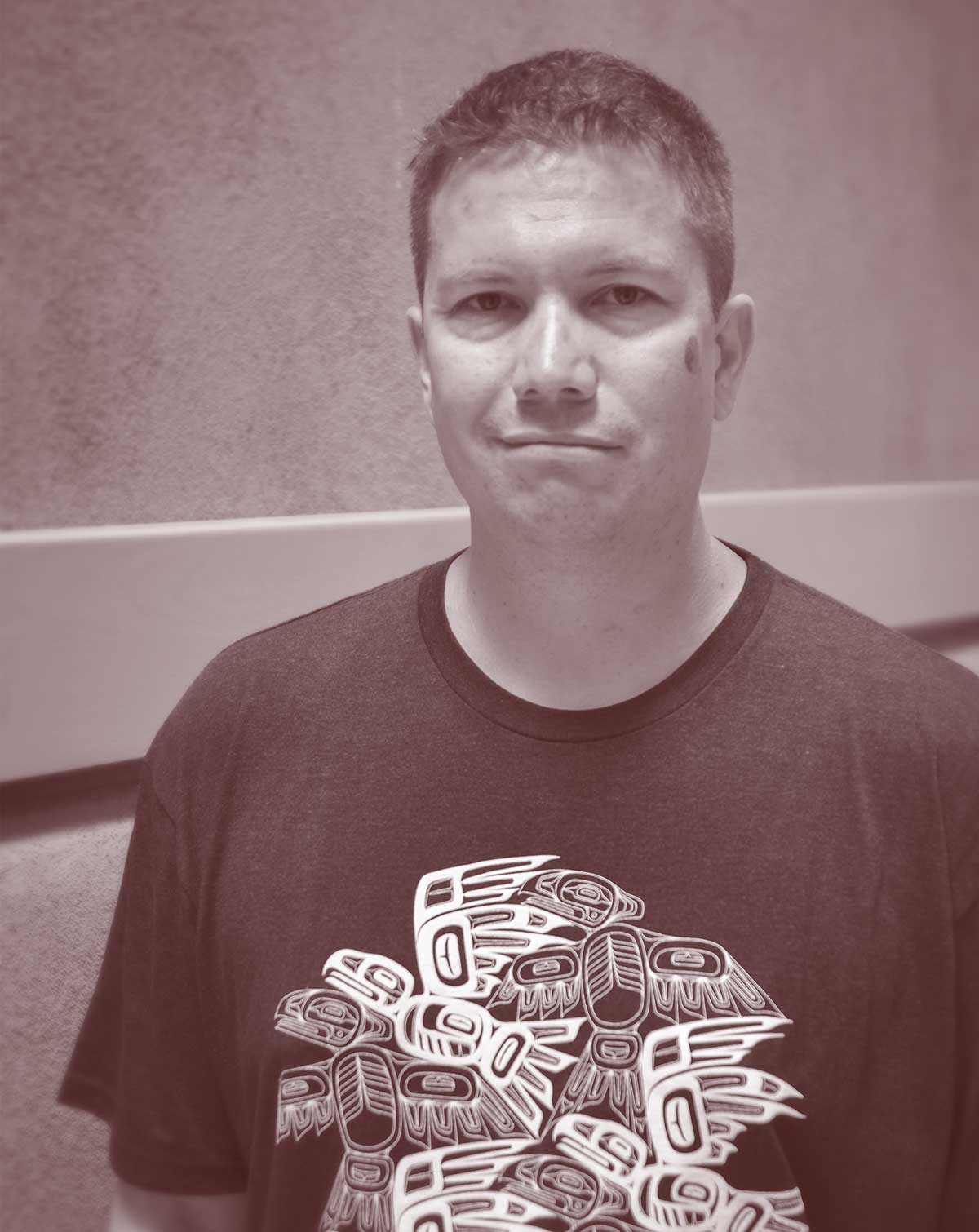 Photo of a man with short hair wearing a t-shirt