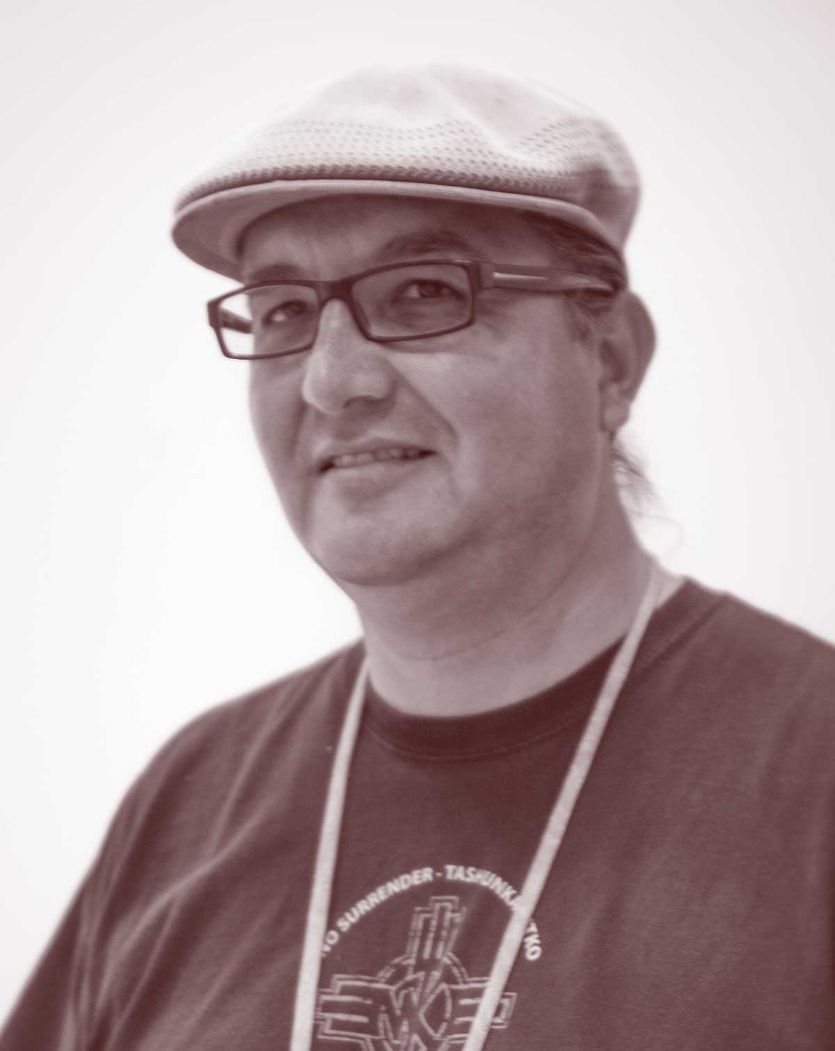 A photo of a man wearing a cap and glasses