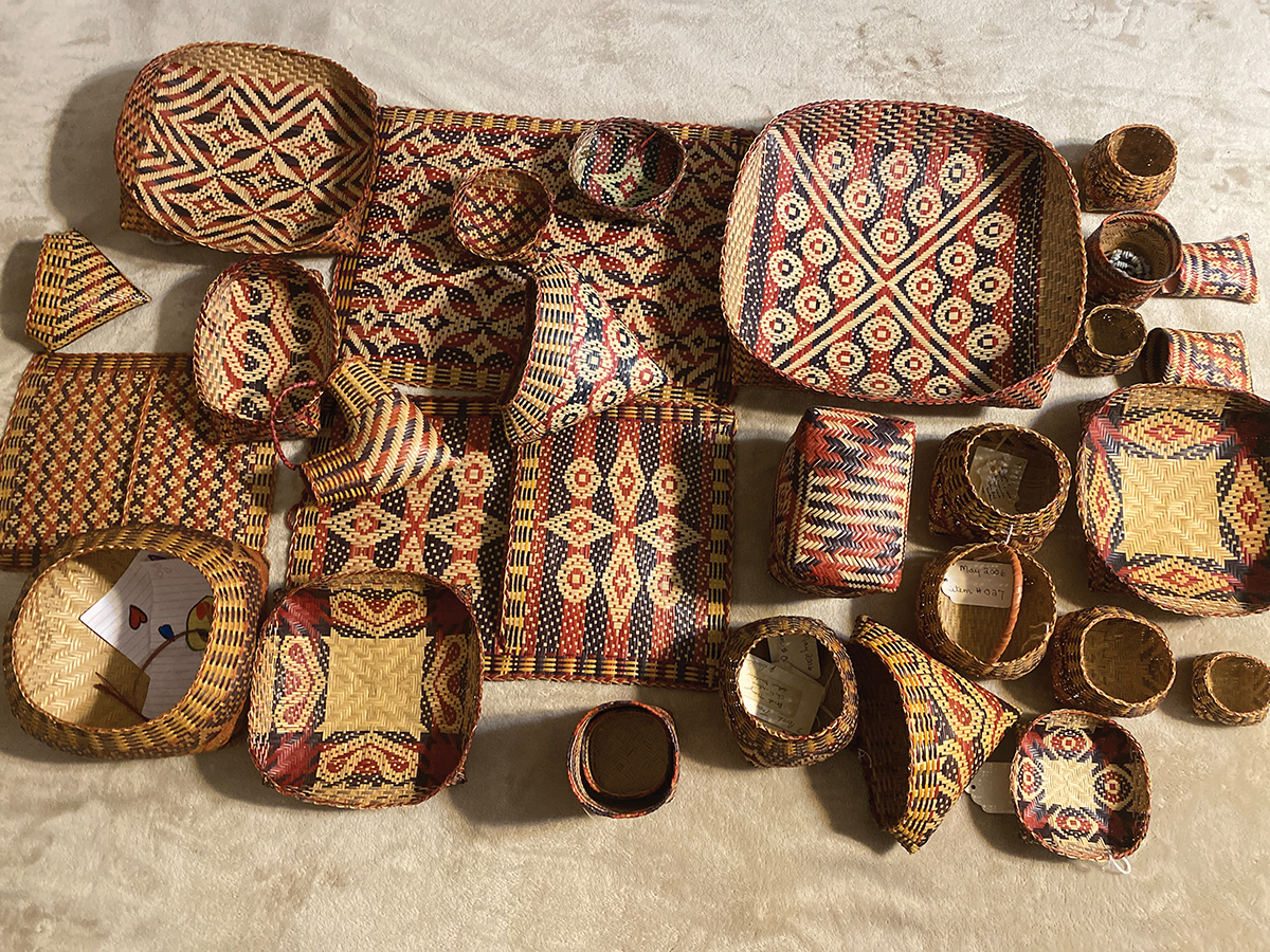 An overhead view of several river cane baskets with traditional designs