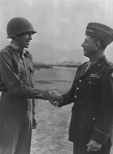 Lt. Ernest Childers being congratulated by Gen. Jacob L. Devers