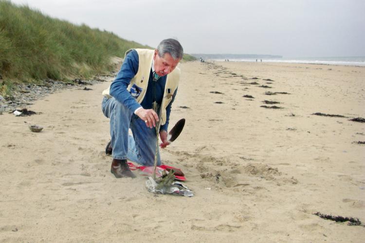 Charles Shay performing his sage ceremony on Omaha Beach