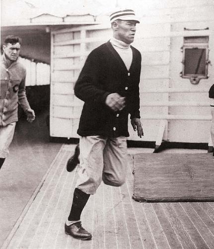 Jim Thorpe training on a running track on the deck of the U.S. Finland