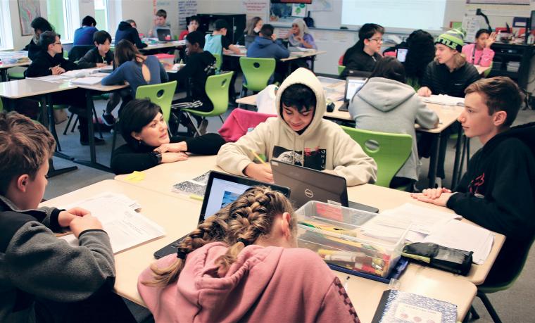 Students at Table with Teacher