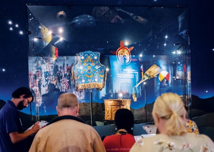 People standing around immersive exhibit