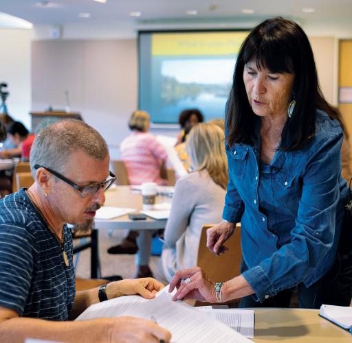 Julie Cajune (Salish) helping a teacher