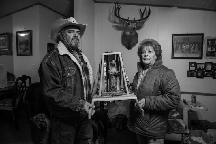Frankie and Carmen López Holding Santo Tomás Bulto
