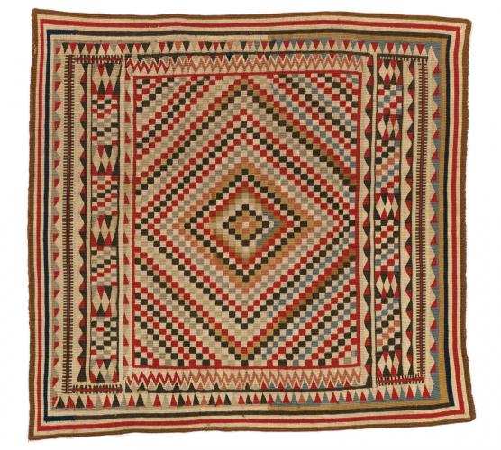 A square woven blanket with a geometric pattern