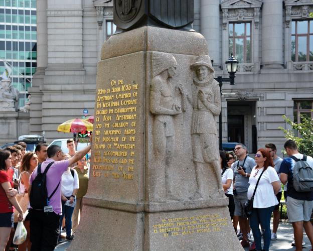 Monument in Battery Park, surrounded by tourists