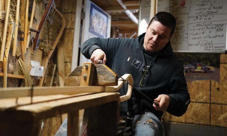 Jack Johnson making a lacrosse stick