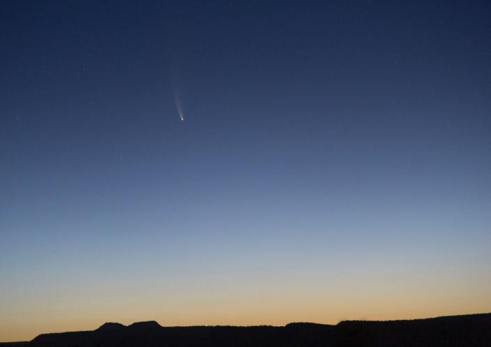 A comet soars through the early morning sky