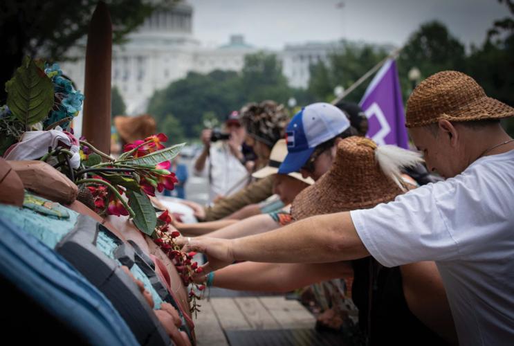 Supporters gather outside the Museum of the American Indian in Washington, D.C., to bless the totem pole