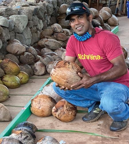 Indrajit Gunasekara holding a coconut.