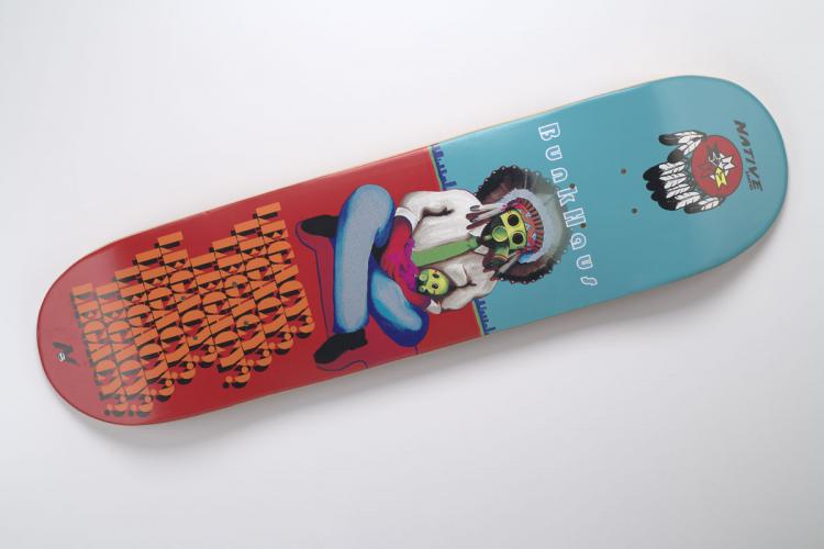 “Legacy” design of man with skull head by Bunky Echo-Hawk on a skateboard.