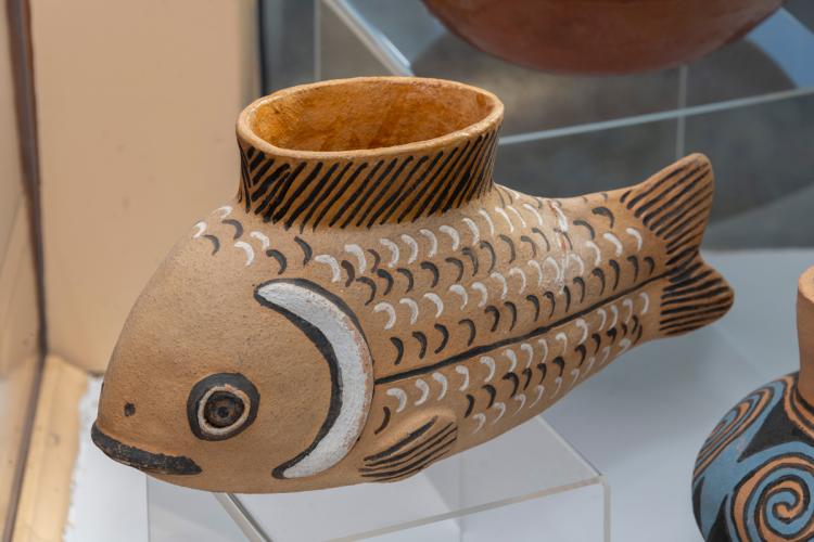 A clay pot shaped like a fish.