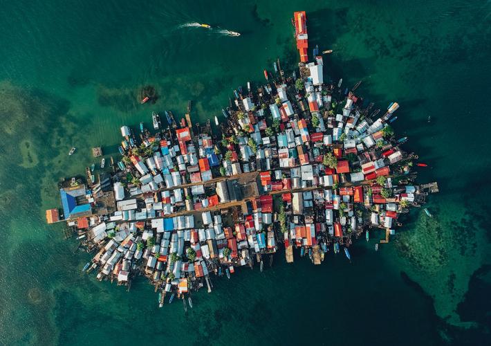An aerial view of a small island completely covered with colorful buildings