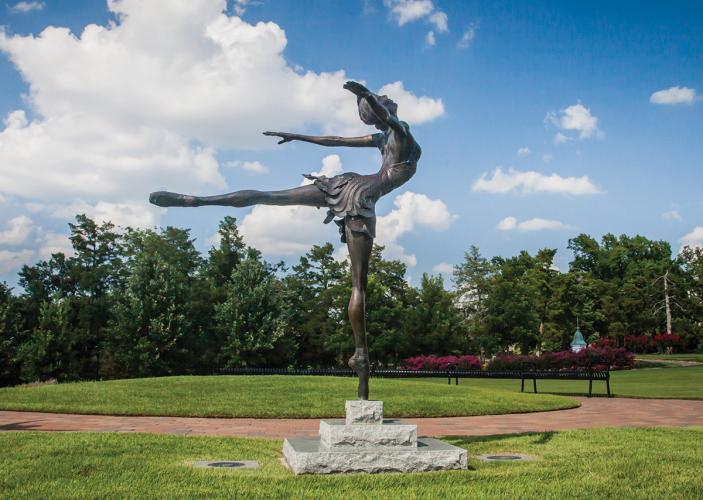 Bronze sculpture of Maria Tallchief posing en pointe, on the toes of one foot, arms splayed