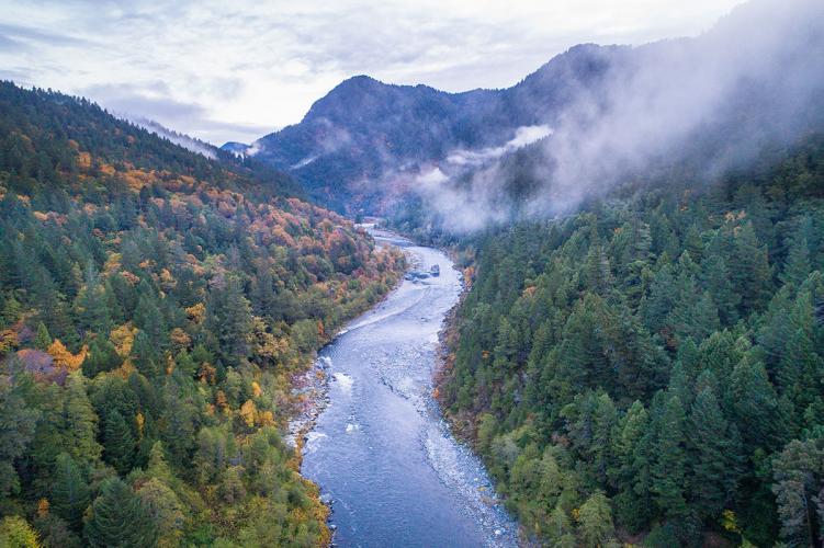 Aerial view of a river curving through a mountainous valley