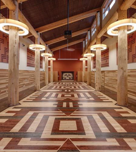 An interior hall with cedar pillars and an inlaid wood floor