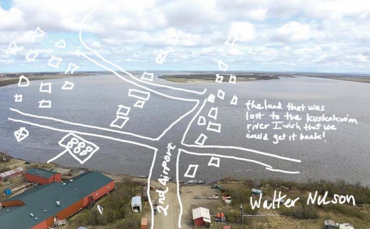 Map drawn by hand over a photo of a flooded village.