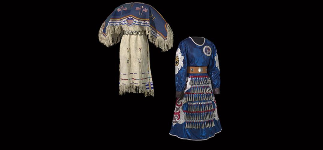 Two dresses stand back to back on mannequins: the dress on the left depicts American flags and stripes made with tanned hide. The dress on the right is constructed with blue fabric and ordained with metallic cones, military patches, and sequins. 