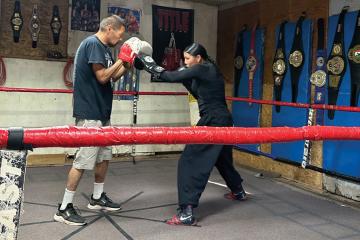 Mariah Bahe trains with her father in a boxing gym