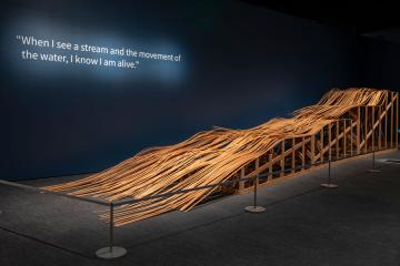 Large wooden sculpture depicting river water 